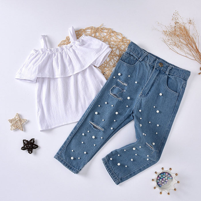 White ruffled suspender top with nail beads and pierced jeans