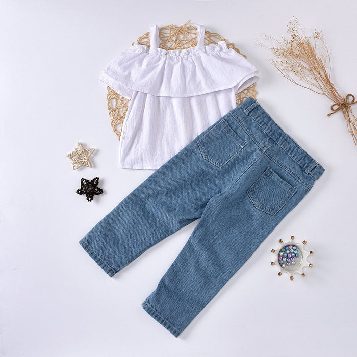 White ruffled suspender top with nail beads and pierced jeans