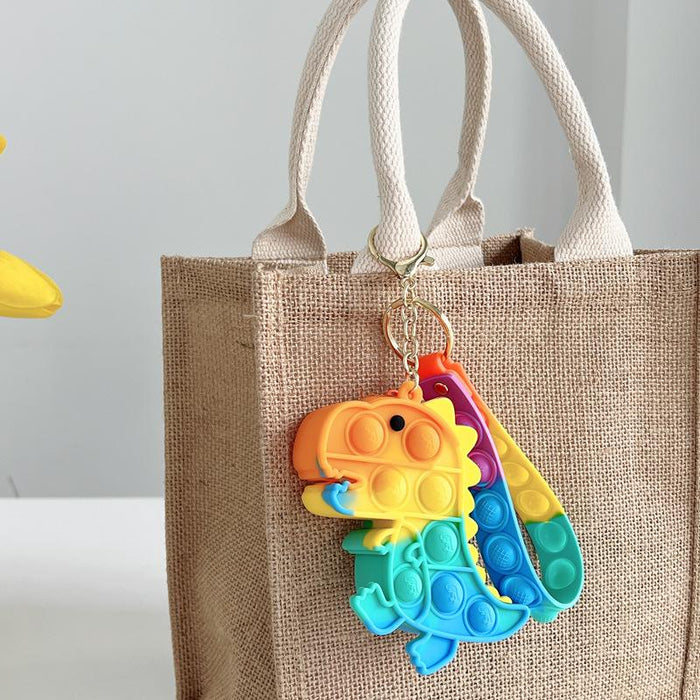 Cartoon astronaut pinching a small coin purse keychain